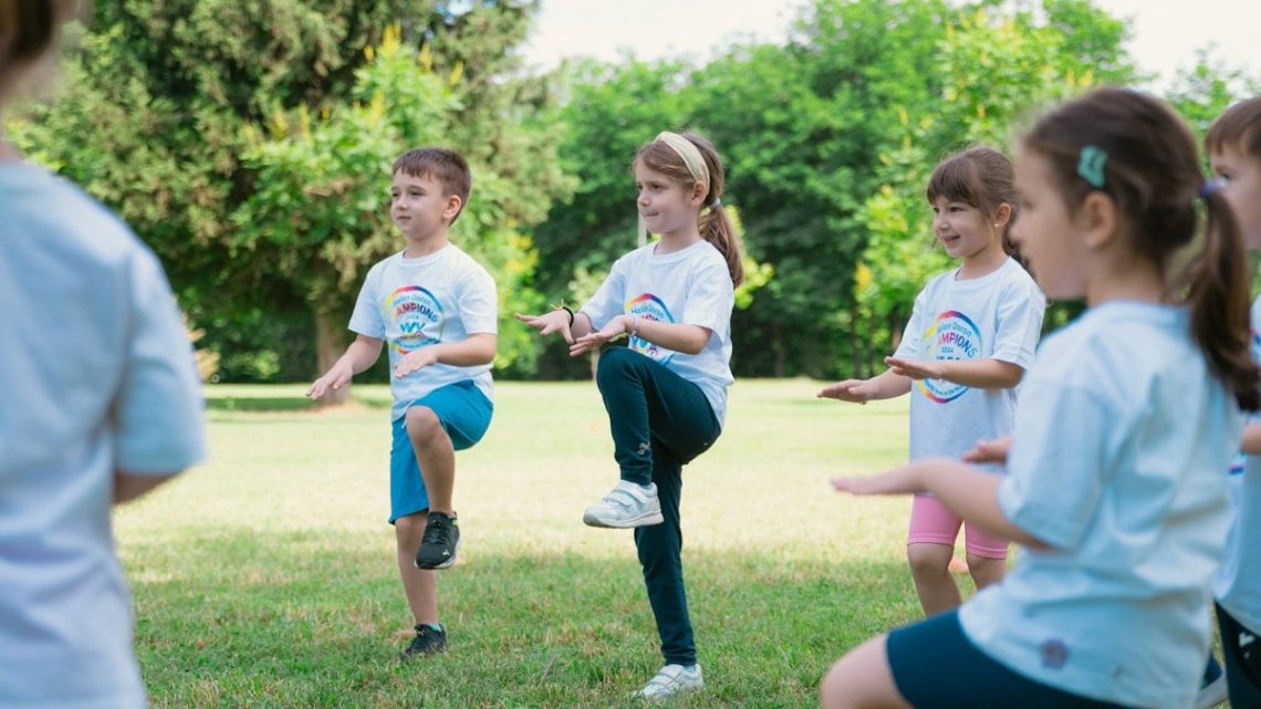 a group of young children playing a game of frisbee