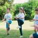 a group of young children playing a game of frisbee